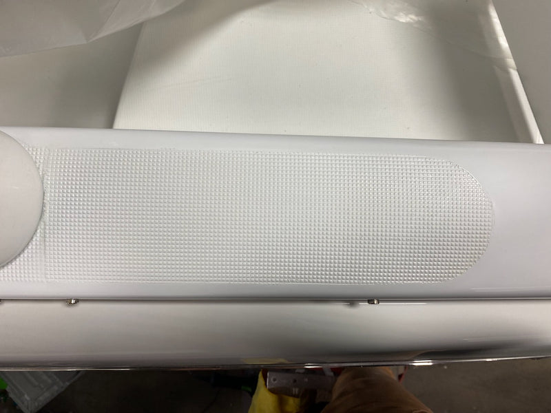 Repaired textured white surface near a boat's rub rail