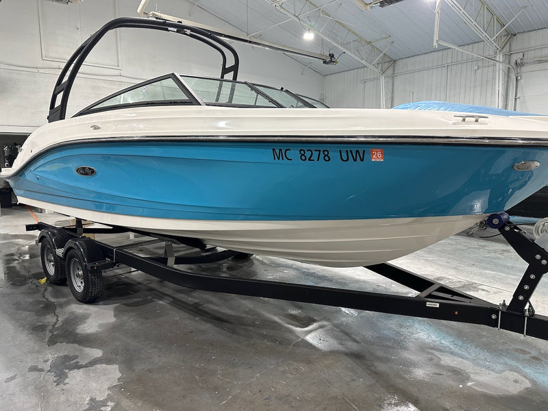 Blue and white boat bow on a trailer after repair