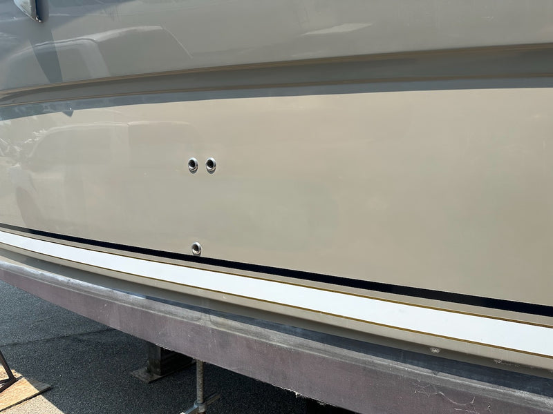 Hull side repaired and sanded, with a white rub rail