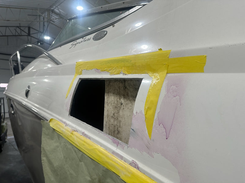 Hull side cut open for a core repair and taped off with yellow tape
