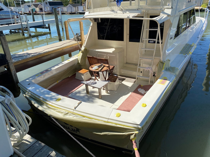 Aft deck of a boat at the dock with tape along the hull