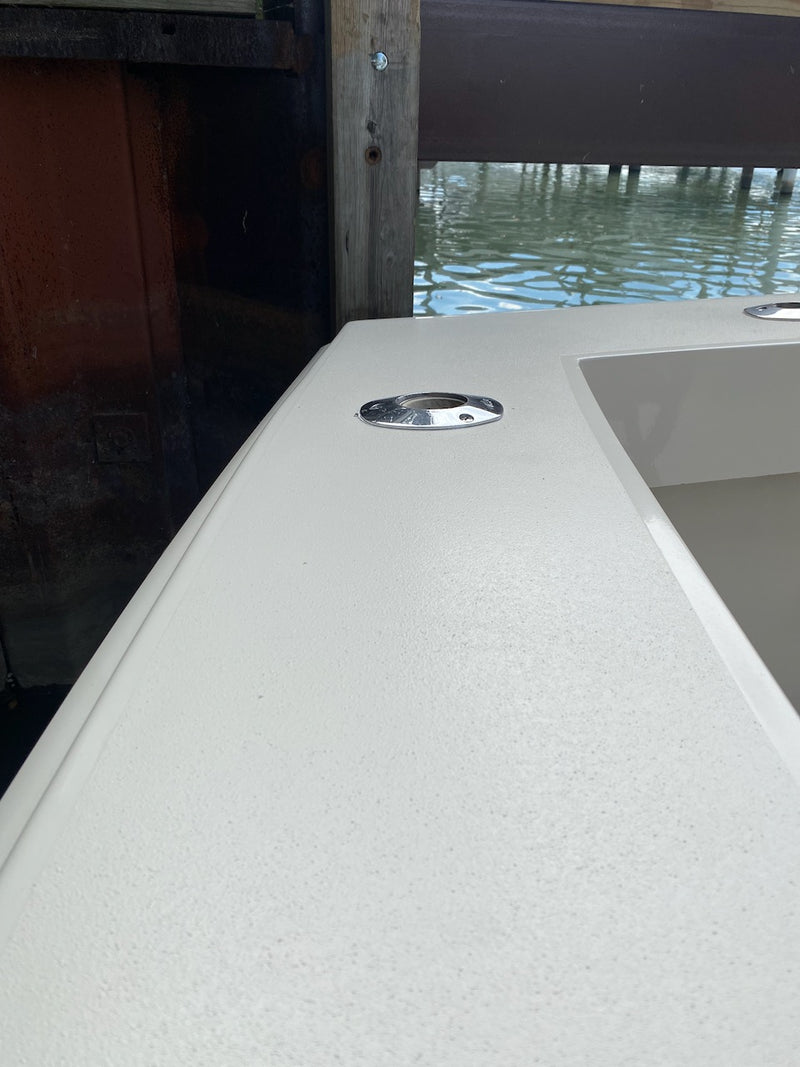 Repaired fiberglass deck edge with a flush hatch, finished in white