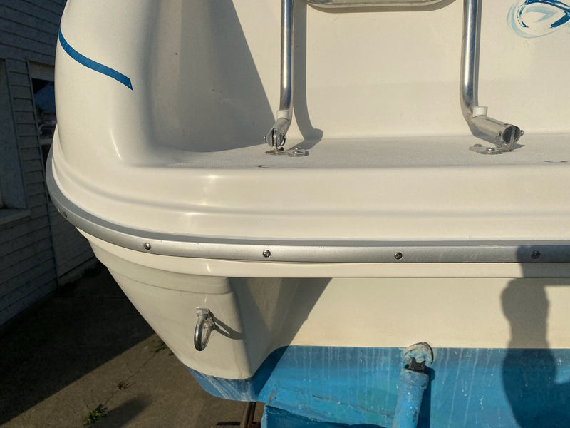 Boat stern corner after repair, smooth white gelcoat above blue bottom paint