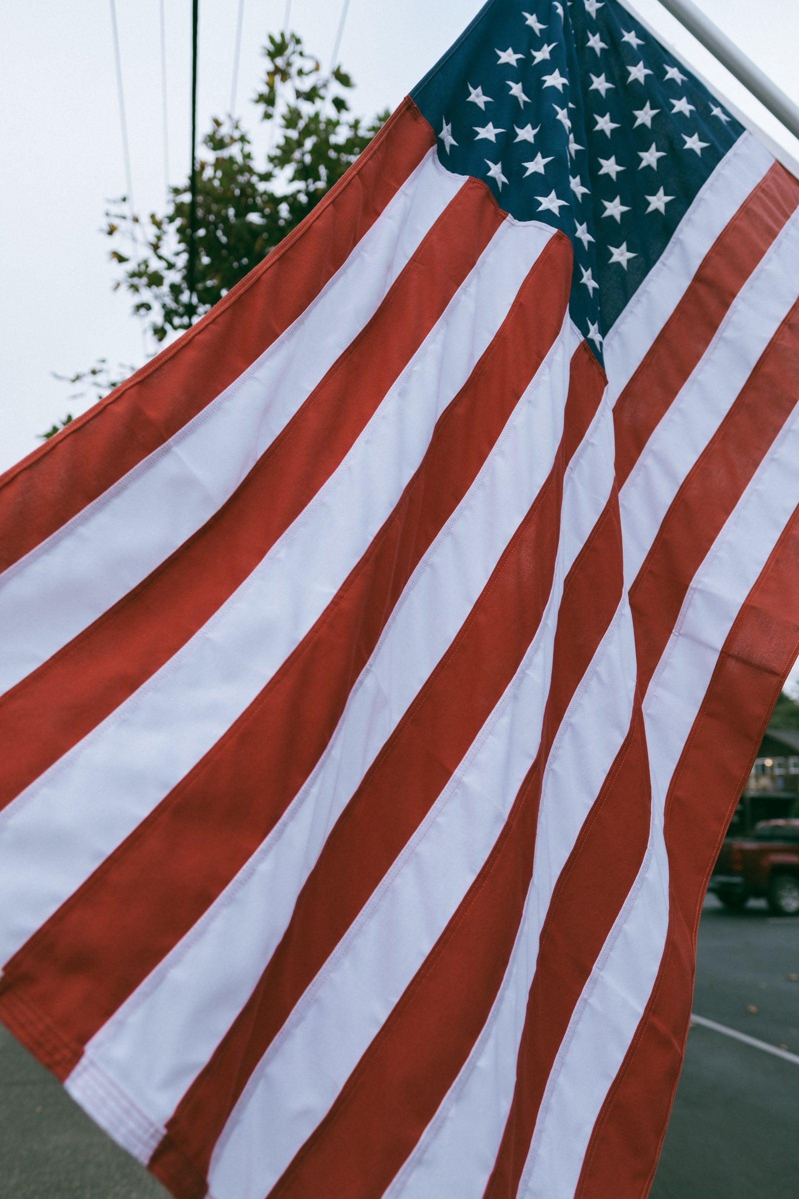 a picture of the American flag up close blowing in the wind.